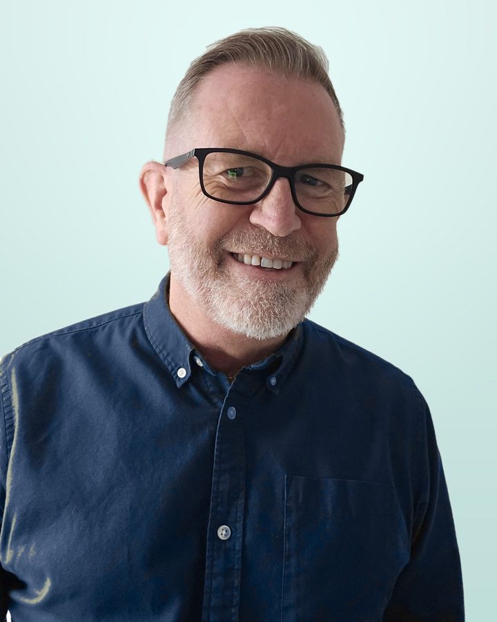 Steve Wood, smiling, in a navy shirt